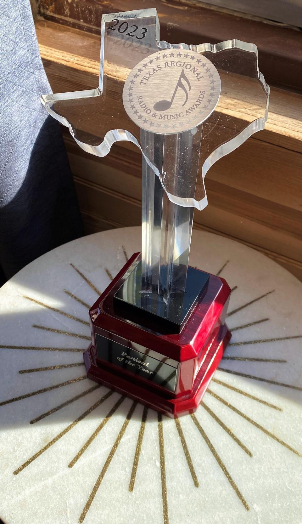 Meredith Powell placed the award given at the Texas Regional Radio Awards to her husband, Mark, for staging the best music festival in the state in 2022, in his office at the Back Porch of Texas. The award was given Monday in Arlington