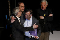 President-elect Gustavo Petro and Francisco de Roux, president of a truth commission, embrace during a ceremony to release a final report by the government-appointed commission regarding Colombia's internal conflict, in Bogota, Colombia, Tuesday, June 28, 2022. A product of the 2016 peace deal between the government and the Revolutionary Armed Forces of Colombia, FARC, the commission was tasked to investigate human rights violations committed by all actors between 1958 and 2016. (AP Photo/Ivan Valencia)
