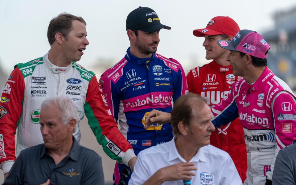 Racing luminaries chat at the Indianapolis Motor Speedway, Saturday, July 30, 2022, during an event to honor past IndyCar and NASCAR winners at this track. 