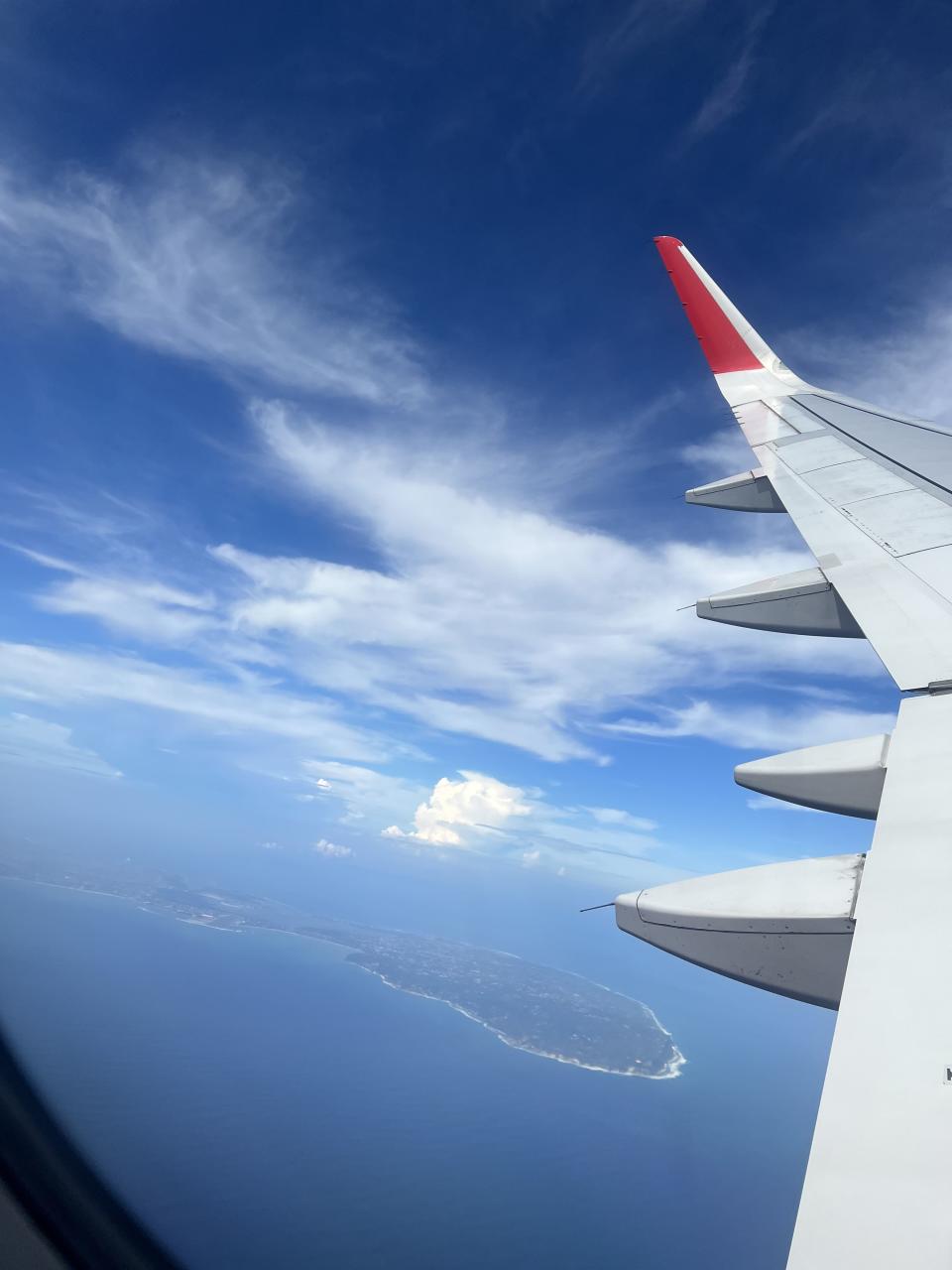 The view of the ocean and an island from an airplane window