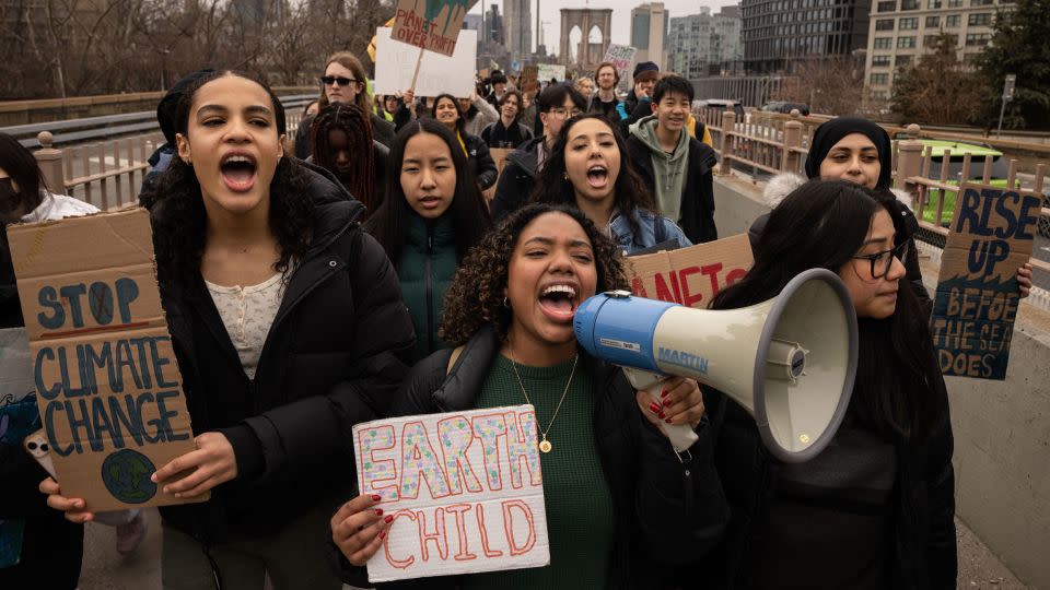 Demonstrators march across the Brooklyn Bridge during a climate change protest in New York on March 3, 2023. - Yuki Iwamura/Bloomberg/Getty Images