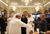 Participants of the Future Investment Initiative forum, "FII", chat during the opening session in Riyadh, Saudi Arabia, Tuesday, Oct. 29, 2019. The three-day forum, beginning on Tuesday, will host financiers, governments, and industry leaders who would discuss global trade and explore the trends, opportunities and challenges shaping the global investment landscape over the coming decades. (AP Photo/Amr Nabil)