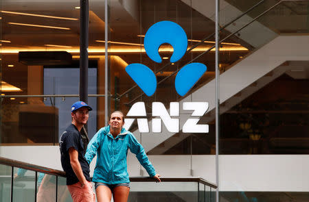 A couple talk in front of an ANZ bank branch in central Sydney, Australia February 20, 2018. REUTERS/Daniel Munoz