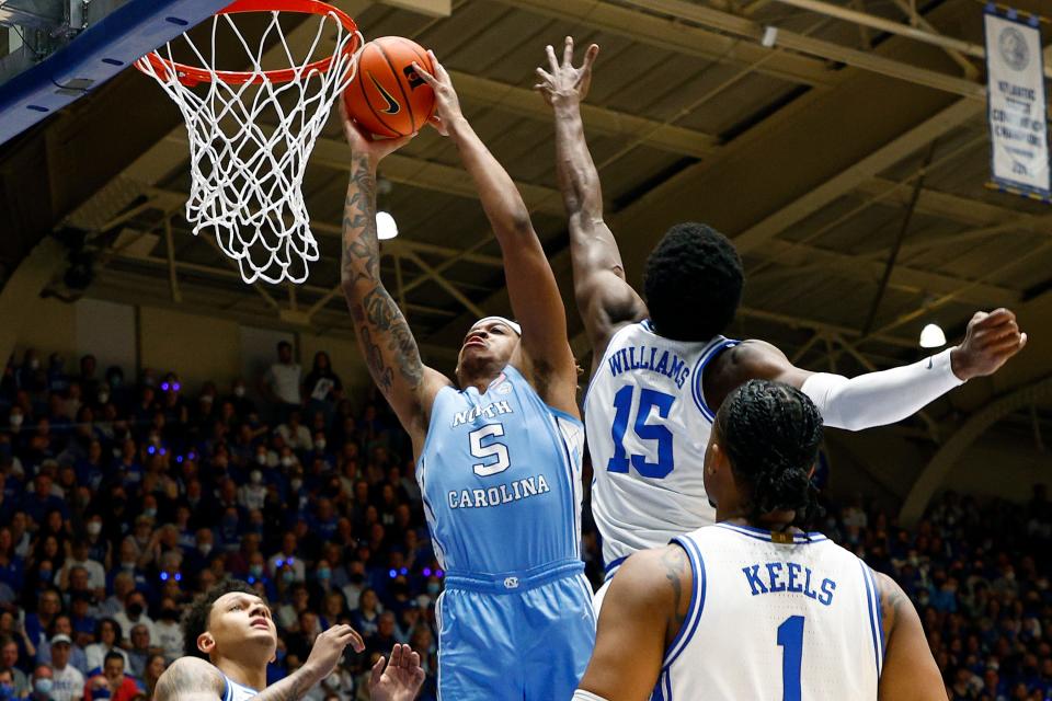Armando Bacot of the North Carolina Tar Heels dunks past Mark Williams of the Duke Blue Devils during the first half at Cameron Indoor Stadium.