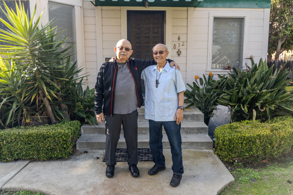 Brothers Lloyd Dong Jr., left, and his brother Ron stand outside of their childhood home on C Street in Coronado.  (San Diego State University)