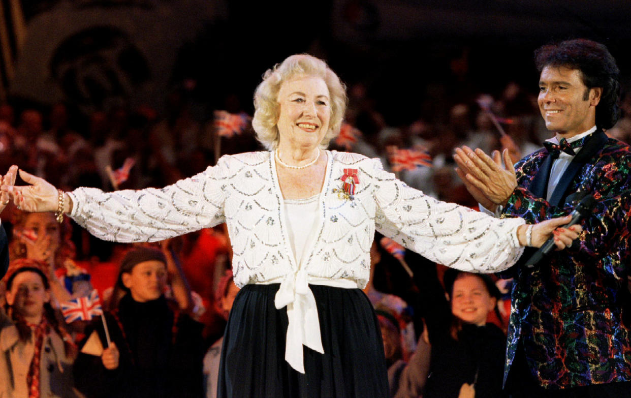 Dame Vera Lynn receives the applause from the audience and fellow performer Cliff Richard during a concert in Hyde Park May 6 commemorating the 50th anniversary of the end of the second world war in Europe