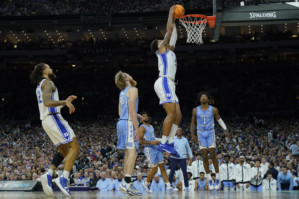 Duke's Paolo Banchero (5) dunks in front of North Carolina's Brady Manek (45) and Leaky Black (1) during the first half of a college basketball game in the semifinal round of the Men's Final Four NCAA tournament, Saturday, April 2, 2022, in New Orleans. (AP Photo/David J. Phillip)