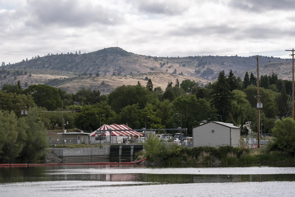 A tent erected by a small group of farmers protesting the lack of water allocation to irrigators sits next to the head gates of the Klamath River on Wednesday, June 9, 2021, in Klamath Falls, Ore. The group has threatened to forcibly open the head gates of the Upper Klamath Lake if the U.S. Bureau of Reclamation does not release water for irrigators. (AP Photo/Nathan Howard)