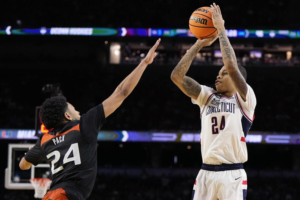 Connecticut guard Jordan Hawkins shoots over Miami guard Nijel Pack during the second half of a Final Four college basketball game in the NCAA Tournament on Saturday, April 1, 2023, in Houston. (AP Photo/Brynn Anderson)