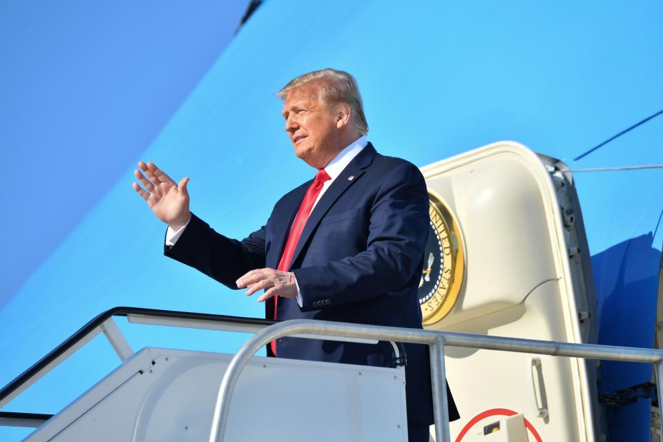 US President Donald Trump waves as he steps off Air Force One at Tulsa International Airport on his way to his campaign rally at the BOK Center on June 20, 2020 in Tulsa, Oklahoma. - Hundreds of supporters lined up early for Donald Trump's first political rally in months, saying the risk of contracting COVID-19 in a big, packed arena would not keep them from hearing the president's campaign message. (Photo by Nicholas Kamm / AFP) (Photo by NICHOLAS KAMM/AFP via Getty Images)