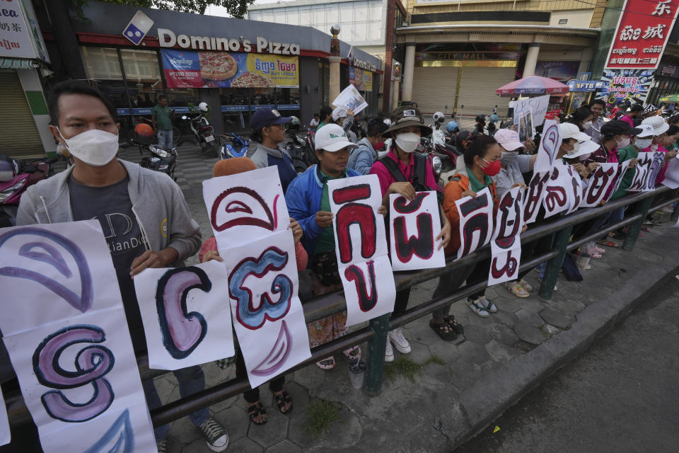 Supporters of NagaWorld's union leader Chhim Sithar, stage a rally in front of Phnom Penh Municipal Court in Phnom Penh Cambodia, Thursday, May 25, 2023. The Phnom Penh Municipal Court is scheduled to announce its verdict on Thursday against Chhim Sithar and her eight union co-defendants. The nine defendants have been charged with incitement to commit felony after they initiated a strike, ongoing since December 2021 in protest of mass layoffs and alleged union-busting. The signs read "The rights to strike. " (AP Photo/Heng Sinith)