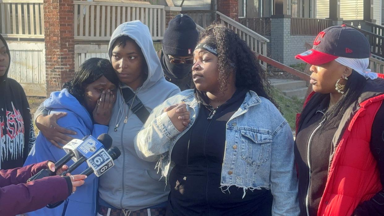 Lakeyshia Timmons' adult children address media at a vigil Friday for their mother. Jessica Thomas (gray sweatshirt) and Latanilia Timmons (second from right) said their mother was the best around.