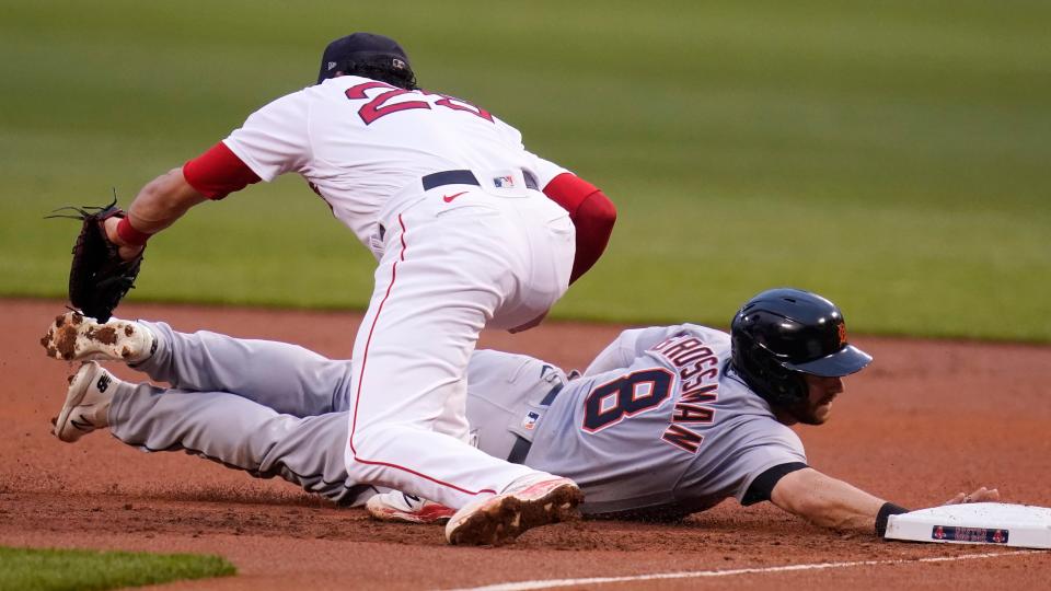 Detroit Tigers' Robbie Grossman (8) dives back safely to first as Boston Red Sox first baseman Bobby Dalbec catches the pick-off throw during the first inning at Fenway Park in Boston on Tuesday, May 4, 2021.