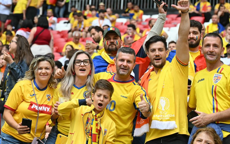 Romania fans pose for a picture ahead of the UEFA Euro 2024 round of 16 football match between Romania and the Netherlands at the Munich Football Arena in Munich on July 2, 2024