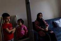 Afghan lawyer Bibi Chaman Hafizi and her children Arsheya and Diana are seen in the living room of their apartment in Athens