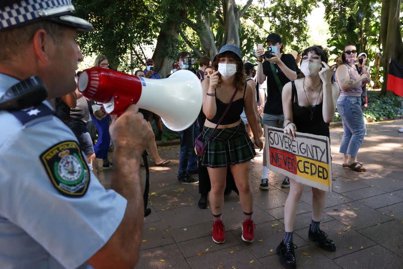 Protesters and police clash during a march on Australia Day in Sydney