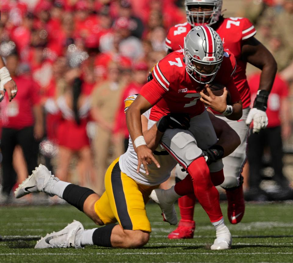 Ohio State quarterback C.J. Stroud is tackled by Iowa defensive lineman Lukas Van Ness on Saturday.