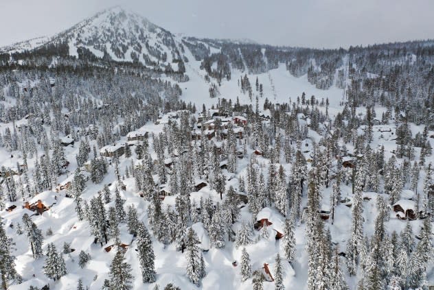MAMMOTH LAKES, CALIFORNIA - MARCH 12: In an aerial view, snow from new and past storms blankets houses and condominiums near Mammoth Mountain chair lifts in the Sierra Nevada mountains, in the wake of an atmospheric river event, on March 12, 2023 in Mammoth Lakes, California.