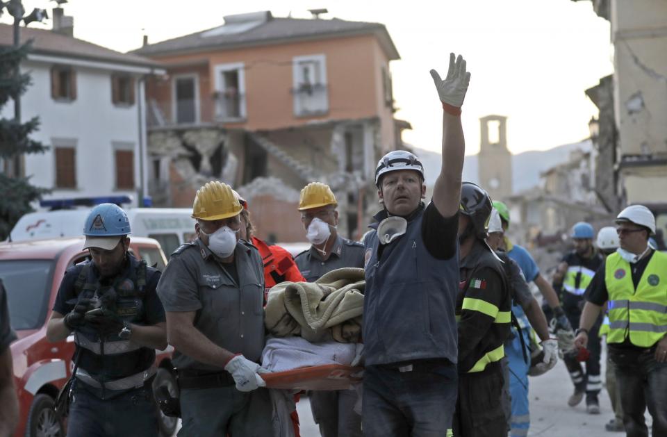 <p>Rescuers carry a body following an earthquake in Amatrice, central Italy, Wednesday, Aug. 24, 2016. (AP Photo/Alessandra Tarantino) </p>