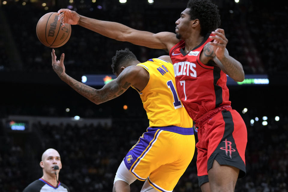 Houston Rockets guard Armoni Brooks (7) and Los Angeles Lakers guard Malik Monk chase the ball during the first half of an NBA basketball game Tuesday, Dec. 28, 2021, in Houston. (AP Photo/Eric Christian Smith)