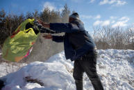 A man who claimed to be from Sudan throws his family's possessions toward the border as he is detained by a U.S. border patrol officer after his family crossed the U.S.-Canada border into Hemmingford, Canada, from Champlain in New York, U.S., February 17, 2017. REUTERS/Christinne Muschi