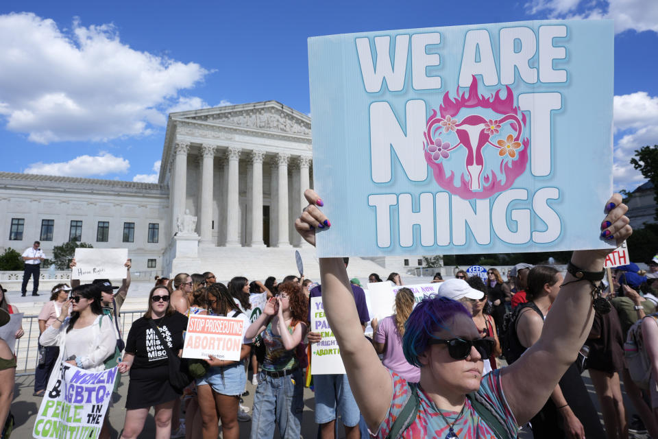 FILE - Abortion rights activists and Women's March leaders protest as part of a national day of strike actions outside the Supreme Court, June 24, 2024, in Washington. A new poll finds that a solid majority of Americans oppose a federal abortion ban and that a rising number support access to abortions for any reason. (AP Photo/Alex Brandon, File)