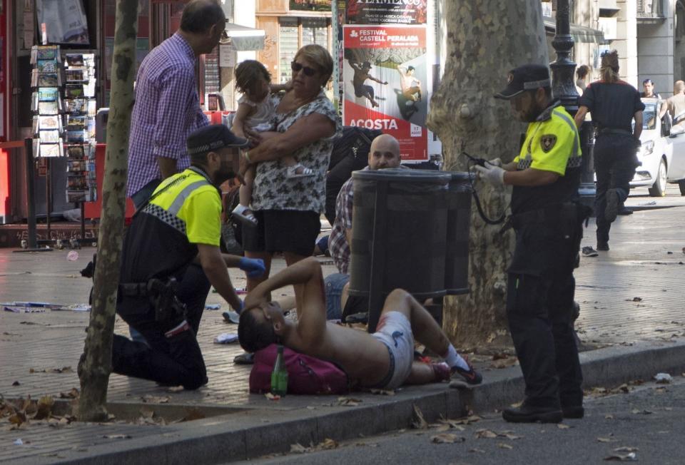 Police officers attend to injured people.&nbsp;