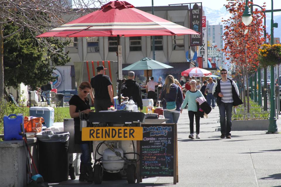 This photo taken June 7, 2013, shows hot dog vendors, or in this case reindeer dog vendors, set up in downtown, Anchorage, Alaska. There's plenty of cultural, historical and fun activities to do in Anchorage for cruise ship passengers who don't want to pay for expensive excursions. (Photo/Mark Thiessen)