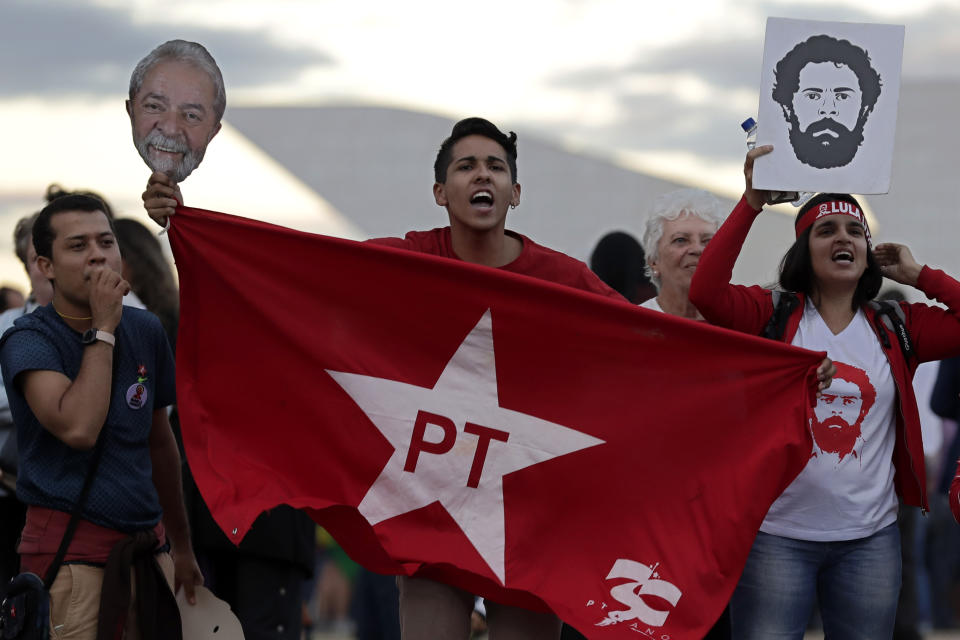 People shout "Free Lula!" outside the Supreme Court where the lawyers of Brazil's former President Luiz Inacio Lula da Silva are asking the court to free him after he was jailed in connection with the "Car Wash" corruption investigation in Brasilia, Brazil, Tuesday, June 25, 2019. Da Silva’s lawyers argue then-judge Sergio Moro offered guidance to prosecutors in investigations that led to da Silva’s conviction. Moro has said he did nothing improper. The court denied the petition to free da Silva. (AP Photo/Eraldo Peres)