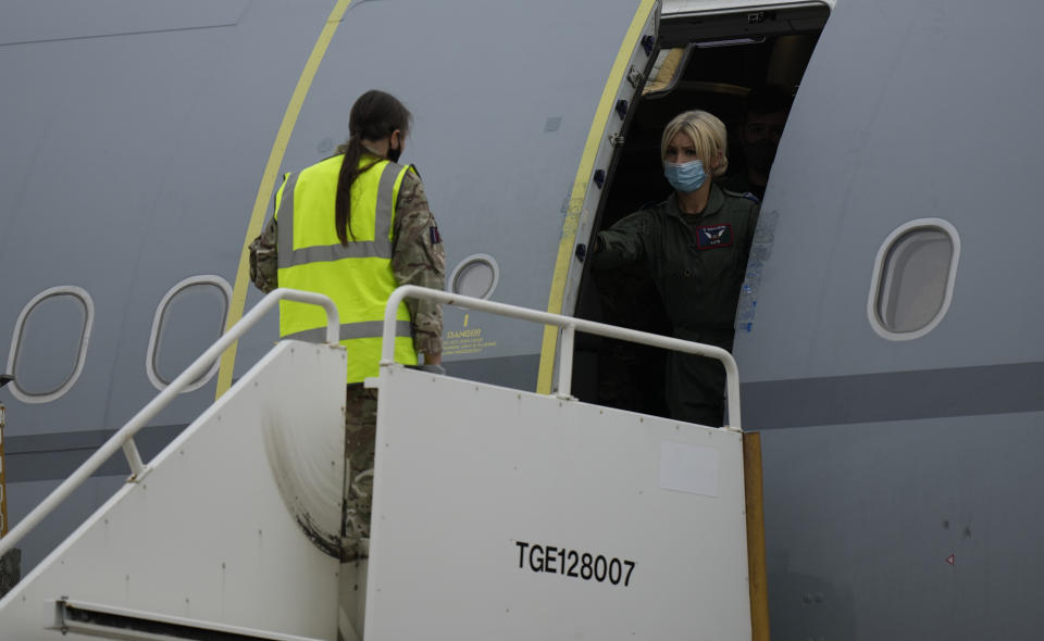 A crew member opens the door of an RAF Voyager aircraft carrying members of the British armed forces 16 Air Assault Brigade after landing at Brize Norton, England, as they return from helping in operations to evacuate people from Kabul airport in Afghanistan, Saturday, Aug. 28, 2021. More than 100,000 people have been safely evacuated through the Kabul airport, according to the U.S., but thousands more are struggling to leave in one of history's biggest airlifts. (AP Photo/Alastair Grant, Pool)