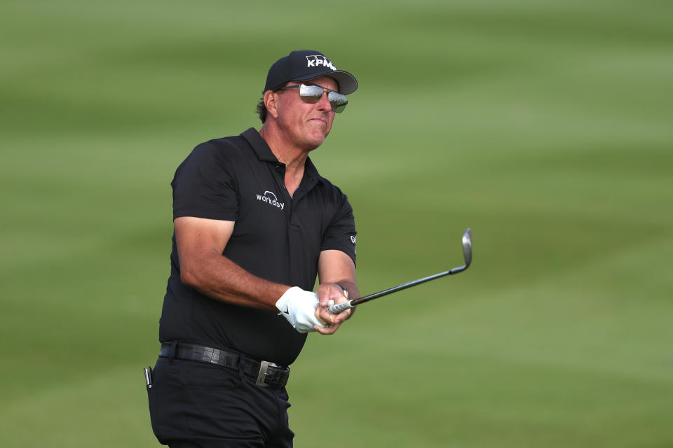 AL MUROOJ, SAUDI ARABIA - FEBRUARY 04:   Phil Mickelson of the United States hits an approach shot on the 17th hole during day two of the PIF Saudi International at Royal Greens Golf & Country Club on February 4, 2022 in Al Murooj, Saudi Arabia. (Photo by Oisin Keniry/Getty Images)