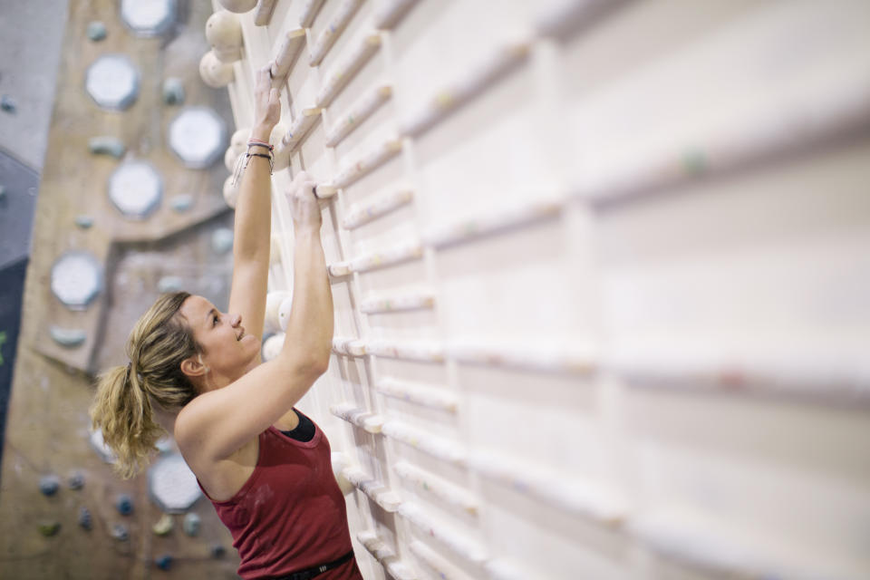 A woman is rock climbing