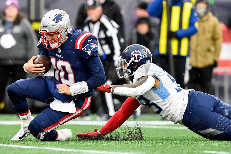 Patriots quarterback Mac Jones is tackled just short of a first down during the third quarter Sunday in Foxboro.