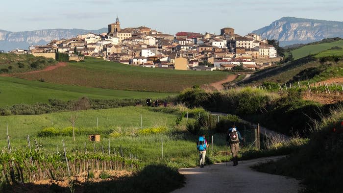 People walking on a dirt road in Spain