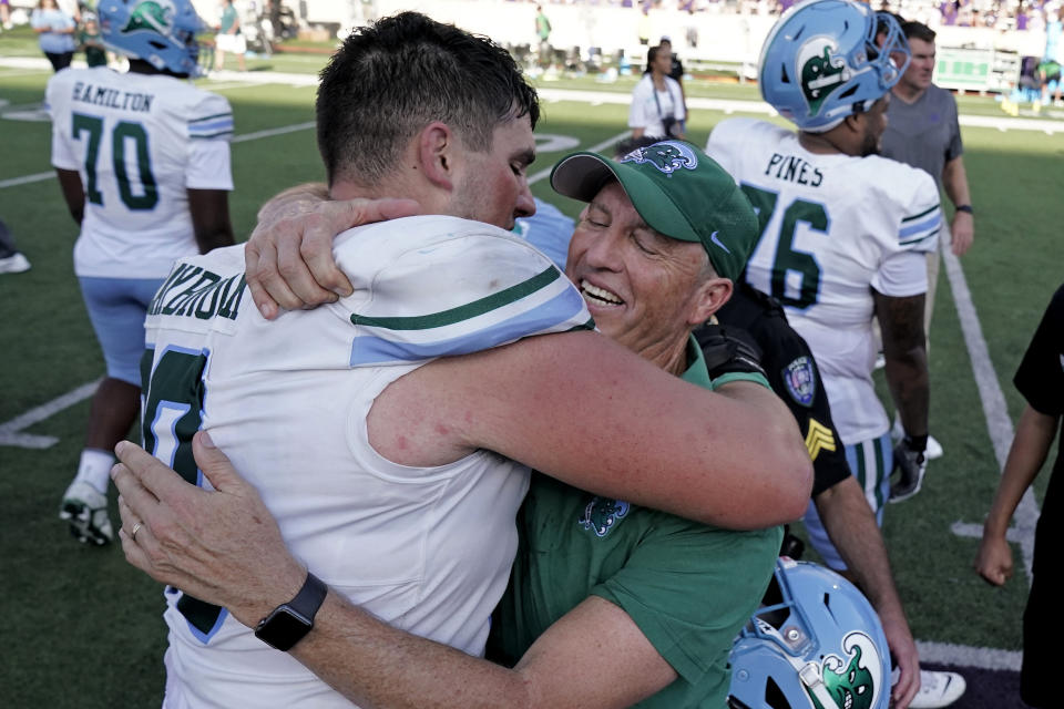 Tulane head coach Willie Fritz celebrates with Tulane offensive lineman Joey Claybrook after their NCAA college football game against Kansas State Saturday, Sept. 17, 2022, in Manhattan, Kan. Tulane won 17-10. (AP Photo/Charlie Riedel)