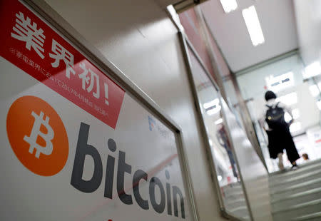 FILE PHOTO: A logo of Bitcoin is seen on an advertisement of an electronic shop in Tokyo, Japan September 5, 2017. REUTERS/Kim Kyung-Hoon/File Photo
