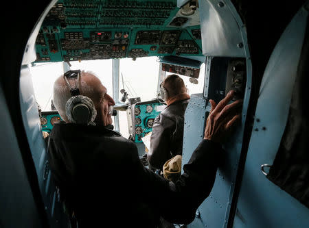 Ukrainian military pilot Mykola Volkozub, who was deployed in a team to fly a helicopter over the reactor to measure the temperature and composition of gases after the accident at the Chernobyl nuclear power plant in 1986, speaks with pilots during a flight inside a Mi-8 helicopter in Kiev Region, Ukraine April 24, 2018. REUTERS/Valentyn Ogirenko