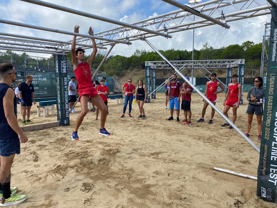 An athlete on an obstacle course at a modern pentathlon test event in Italy.