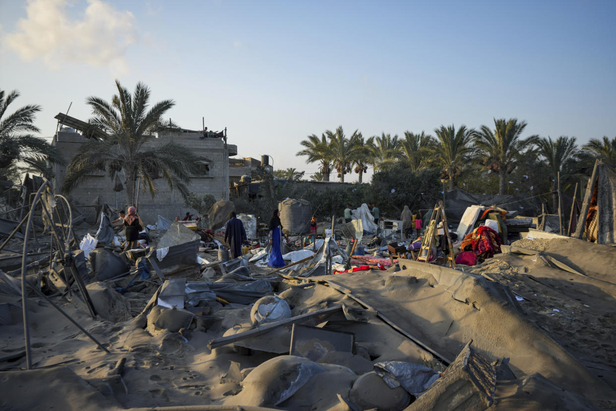 Palestinians look at the destruction after an Israeli airstrike on a crowded tent camp housing Palestinians displaced by the war in Muwasi, Gaza Strip, Tuesday, Sept. 10, 2024. An Israeli strike killed at least 40 people and wounded 60 others early Tuesday, Palestinian officials said. Israel said it targeted "significant" Hamas militants, allegations denied by the militant group. (AP Photo/Abdel Kareem Hana)