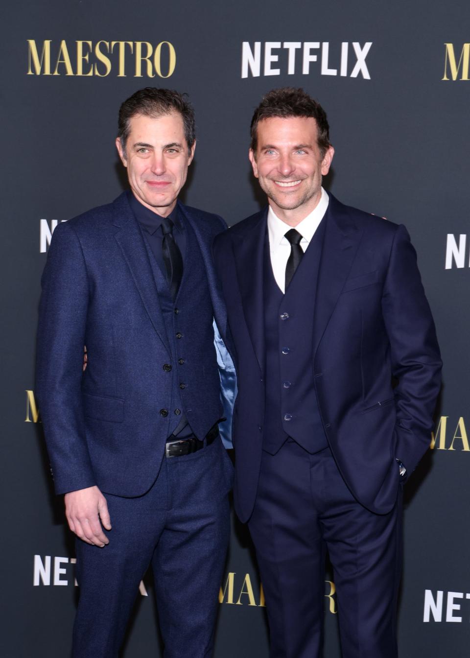 Josh Singer and Bradley Cooper in blue suits at Netflix's "Maestro" LA special screening