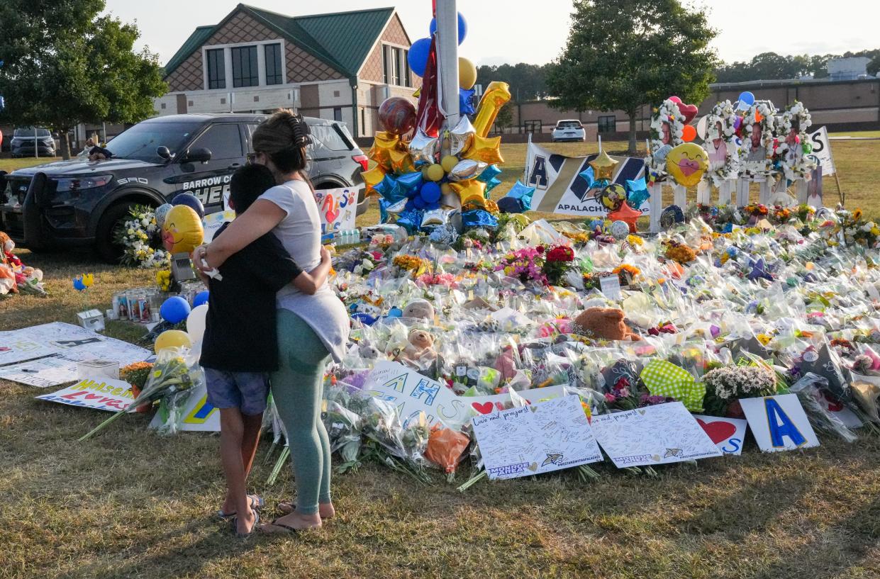 Mourners gather at Apalachee High School in Barrow County, Georgia, the evening before classes resumed across the district, less than a week after two teachers and two students were gunned down, investigators say, by a 14-year-old student.