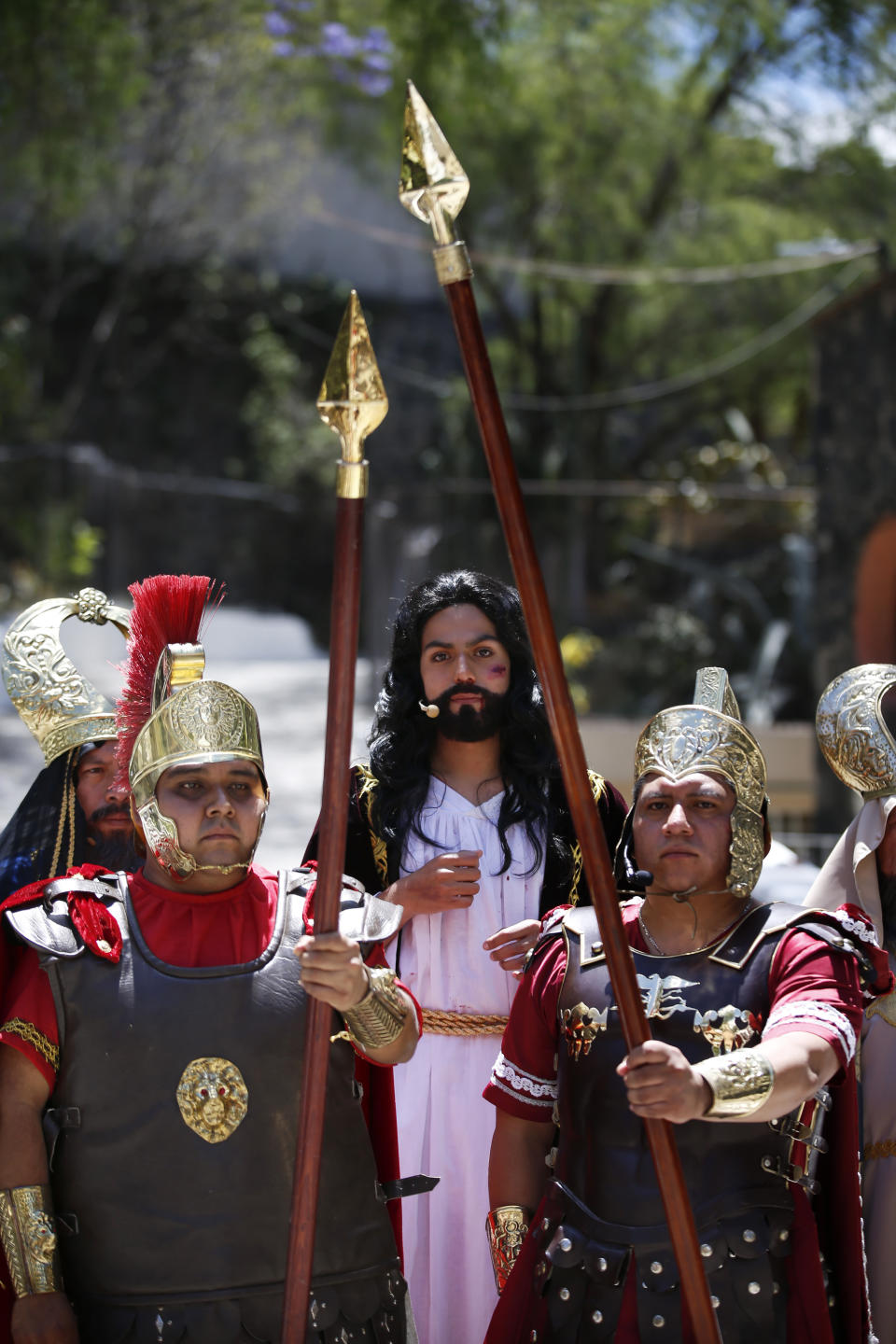 Men dressed as Roman soldiers escort Brando Neri Luna in the role of Jesus Christ during the Passion Play of Iztapalapa, outside the Cathedral, on the outskirts of Mexico City, Friday, April 2, 2021, amid the new coronavirus pandemic. To help prevent the spread of the COVID-19, Latin America's most famous re-enactment of the crucifixion of Christ was closed to the public and transmitted live so people could watch at home, for a second consecutive year. (AP Photo/Marco Ugarte)