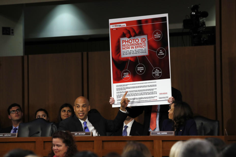 Sen. Cory Booker, D-N.J., points at an example of voter ID signage as he questions Brett Kavanaugh on Sept. 5. (Photo: Jacquelyn Martin/AP)