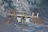 Backdropped by Earth, the International Space Station is seen in this image photographed by an STS-130 crew member on space shuttle Endeavour after the station and shuttle began their post-undocking relative separation, in this undated NASA handout photo. The shutdown idled most of NASA's 18,000 workers. Only 550 employees were considered exempt, including two American astronauts serving aboard the International Space Station and flight directors at Mission Control in Houston. Skeleton staff maintain key science and communications satellites but work on new missions, including preparations to launch a Mars probe on Nov. 18, have been suspended, said NASA. REUTERS/NASA/Handout via Reuters (UNITED STATES - Tags: SCIENCE TECHNOLOGY POLITICS BUSINESS) ATTENTION EDITORS - THIS IMAGE WAS PROVIDED BY A THIRD PARTY. FOR EDITORIAL USE ONLY. NOT FOR SALE FOR MARKETING OR ADVERTISING CAMPAIGNS. THIS PICTURE IS DISTRIBUTED EXACTLY AS RECEIVED BY REUTERS, AS A SERVICE TO CLIENTS