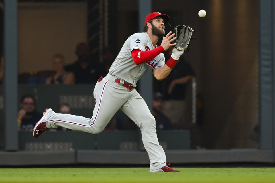 Philadelphia Phillies right fielder Bryce Harper catches a fly ball off the bat of Atlanta Braves' Ronald Acuna Jr. during the first inning of a baseball game Saturday, June 15, 2019, in Atlanta. (AP Photo/John Amis)