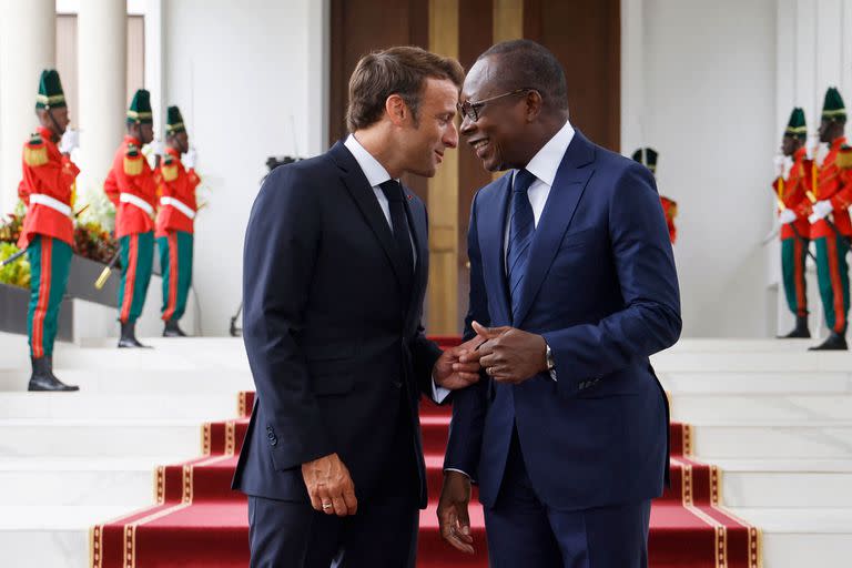 French President Emmanuel Macron (L) meets with Beninese President Patrice Talon during an official visit at the Presidential Palace in Cotonou on July 27, 2022. (Photo by Ludovic MARIN / AFP)