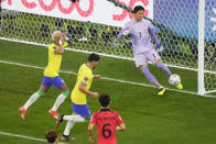 Brazil's Neymar, left, celebrates after scoring on a penalty kick against South Korea's goalkeeper Kim Seung-gyu (1) during the World Cup round of 16 soccer match between Brazil and South Korea, at the Education City Stadium in Al Rayyan, Qatar, Monday, Dec. 5, 2022. (AP Photo/Ariel Schalit)