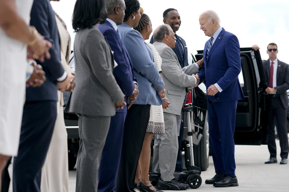 Former Atlanta Mayor Andrew Young, shakes hands with President Joe Biden, right, as Atlanta Mayor Andre Dickens looks on, as Biden arrives at Dobbins Air Reserve Base, Thursday, June 27, 2024, in Marietta, Ga., en route to Atlanta to attend the presidential debate. (AP Photo/Evan Vucci)