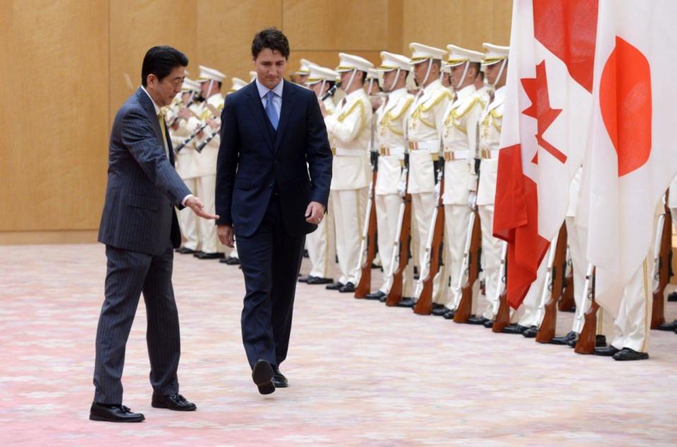 Prime Minister Justin Trudeau inspects an honour guard as he walks with Japan Prime Minister Shinzo Abe, left, at the Kantei in Tokyo, Japan, on Tuesday, May 24, 2016. THE CANADIAN PRESS/Sean Kilpatrick