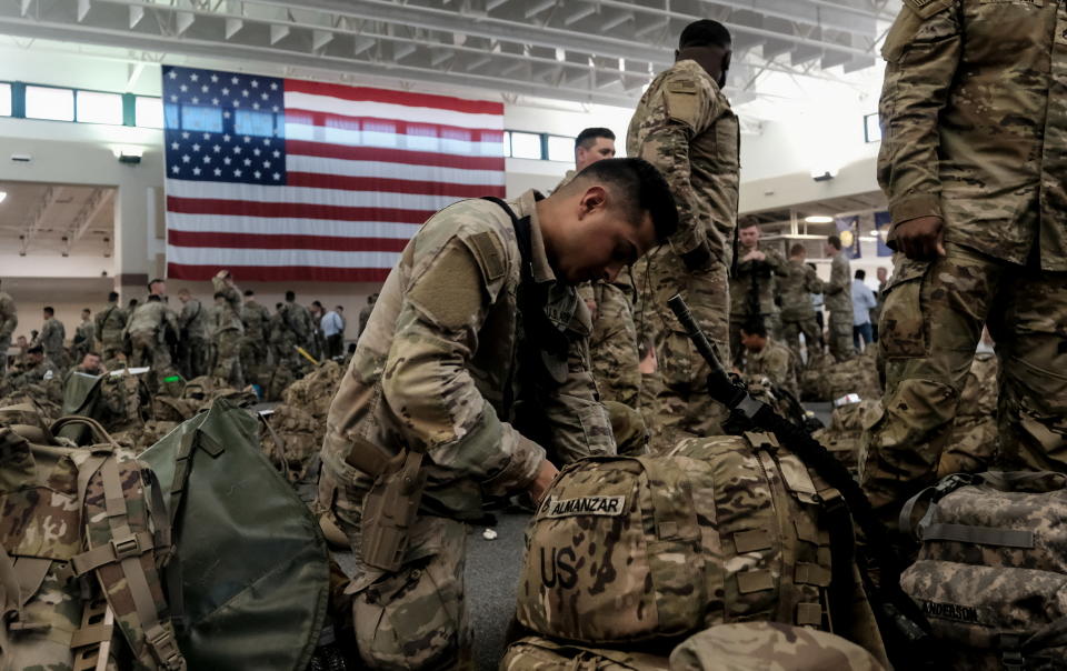 Soldiers from the U.S. Army’s 1st Armored Brigade Combat Team rest while waiting at a staging area before boarding a transport plane bound for Europe, on a deployment launched in response to the invasion of Ukraine by Russia, at Hunter Army Airfield, Georgia , U.S., March 2, 2022. REUTERS/Michael A. McCoy